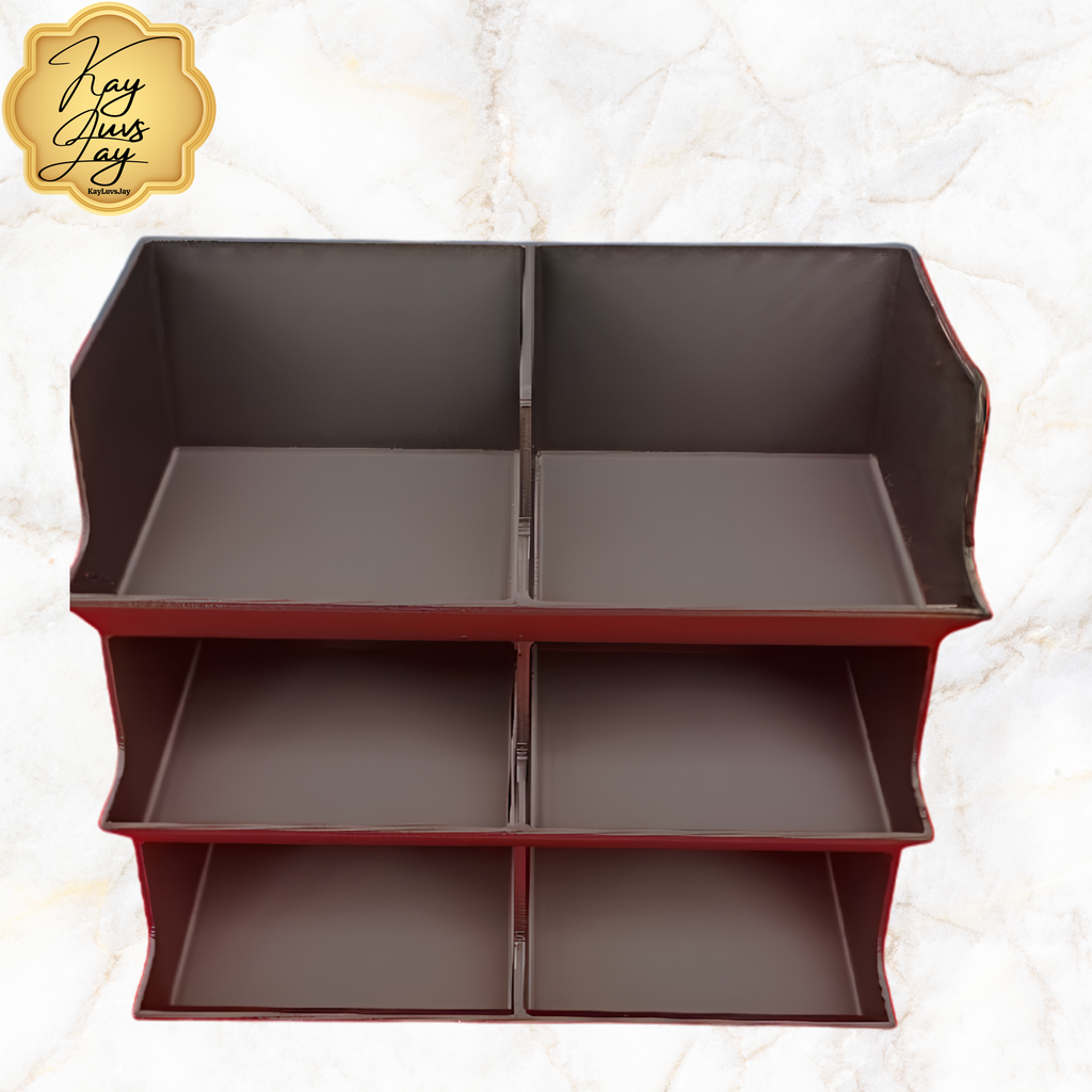 Black storage shelf with multiple compartments on a light marble background