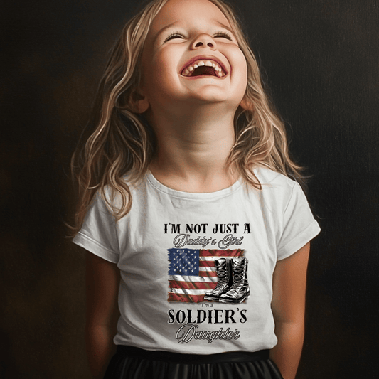 toddler wearing a patriotic t-shit with a flag and boots that says I'm not just a daddy's girl I am a Soldier's Daughter
