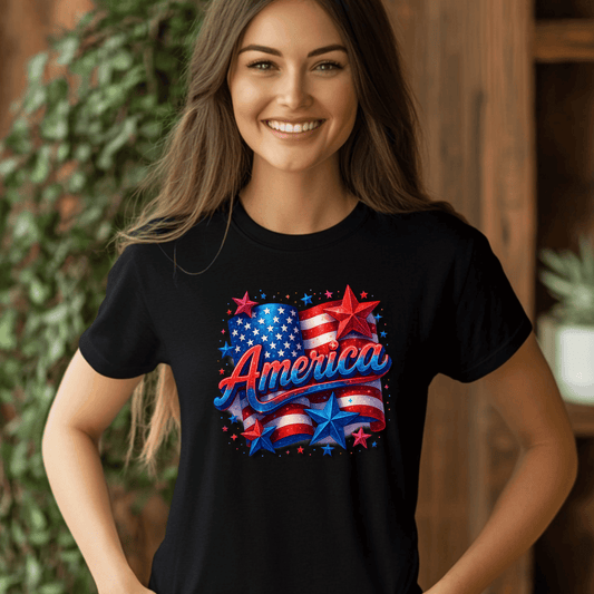 Smiling woman wearing a black t-shirt with a bold, patriotic “America” design featuring sparkling 3D red, white, and blue text, a waving American flag, and glittery stars—perfect for celebrating the 4th of July, Independence Day, or showing USA pride.