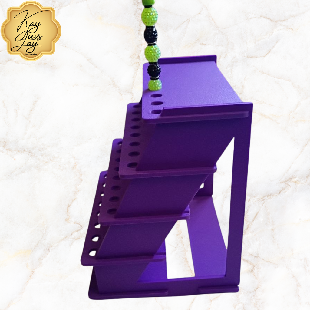 Purple pet step with green and black beads on a textured white background