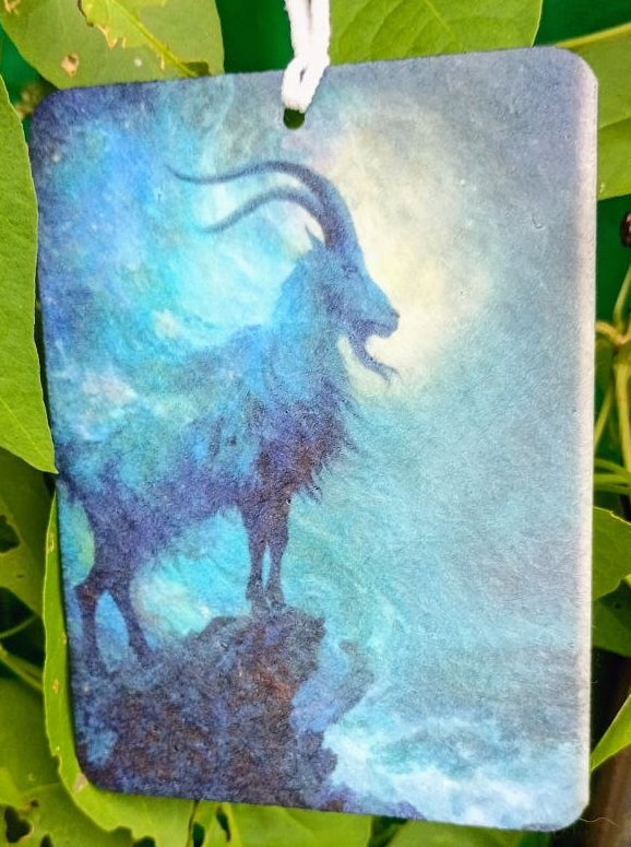 Decorative air freshener with a goat design on a green leafy background