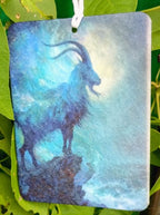 Decorative air freshener with a goat design on a green leafy background