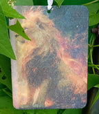 Decorative tag with a horse design hanging among green leaves