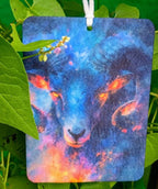 Colorful bear painting hanging among green leaves