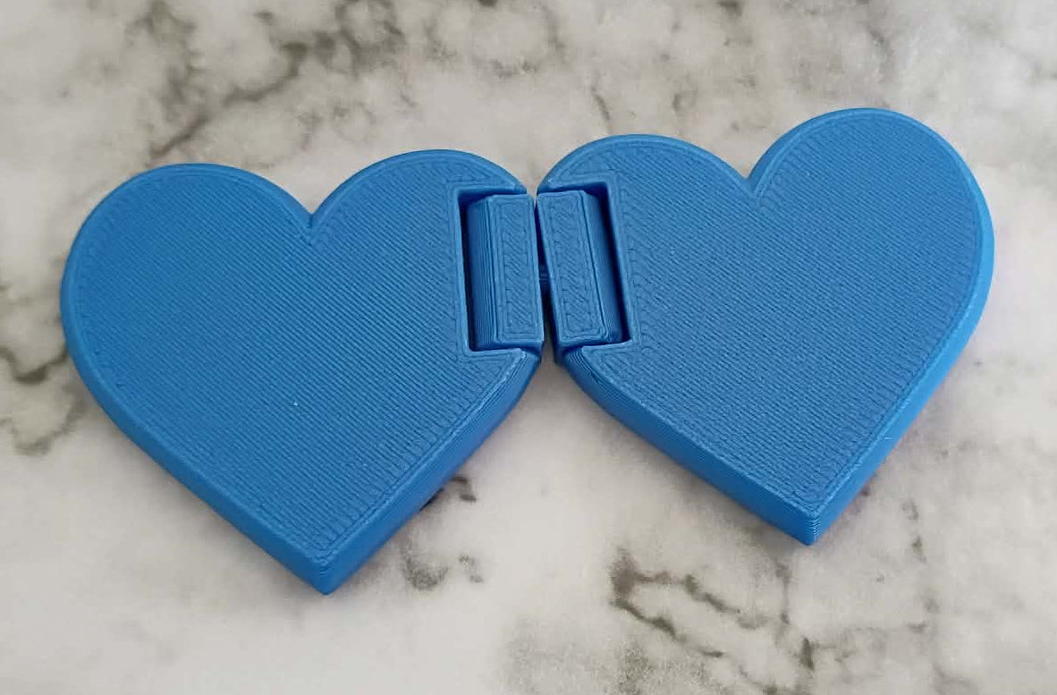 Blue heart-shaped cookie cutter on a marble surface