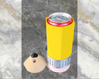 Yellow can cooler with a pink base on a marble background, labeled '16 oz Skinny'.