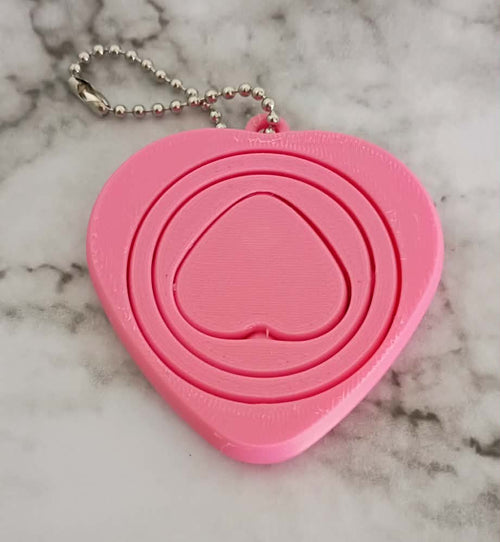 Pink heart-shaped object on a marble surface