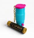 Blue lip balm container with pink cap and gold chain, next to a black lip balm tube on a white background.
